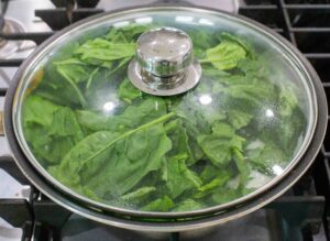 spinach on cover pan