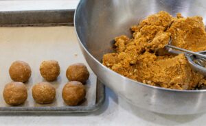 Scooping and rolling the cookie truffles.