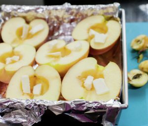 Apples halves with butter ready to baked.