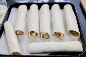 Taquitos filled ready to go to the oven.