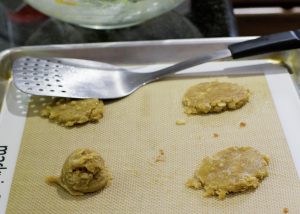 Pressing the brandy cookies.