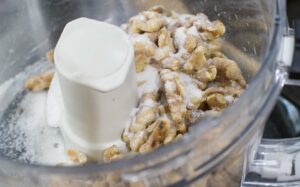 Walnuts and sugar in food processor 