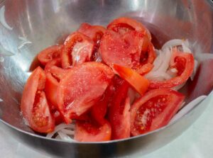 tomato and onions in a bowl