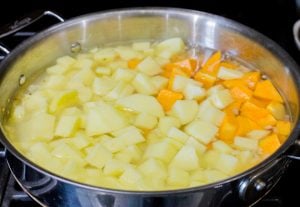 Potatoes and squash covered with water.