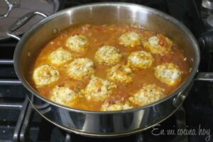 Skillet with tomato sauce and fish balls.