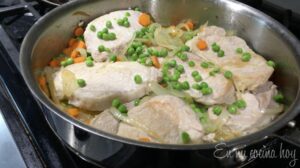 Peas, carrots, onions and pork on the sautéed pan