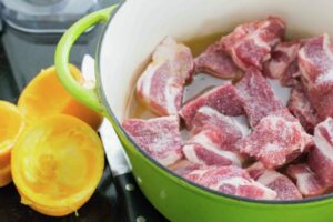 Pork on a pot with orange juice