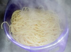 Drain cooked spaghetti.