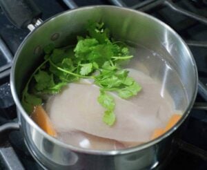 Chicken breast cooking in a pot