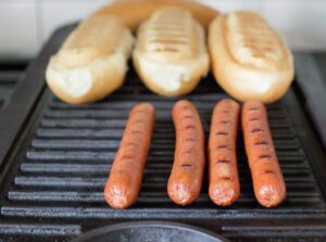 Grilling the hot dogs.