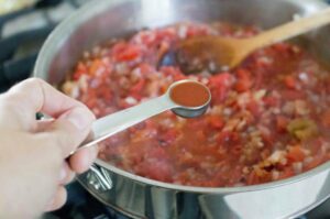 Cooking the tomatoes and onion down.