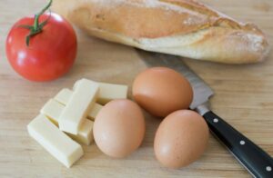 Ingredients for scrambled eggs with cheese and tomatoes