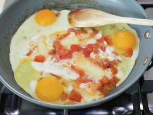 Eggs, cheese and tomatoes in a pan