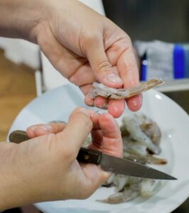 Cleaning raw shrimp.