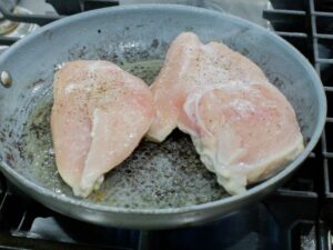 Cooking the chicken breast.