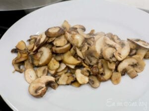 Plate with cooked mushrooms.