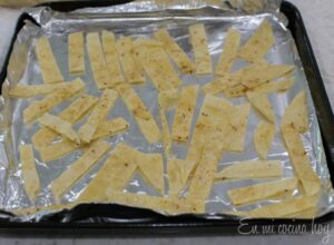 Tortilla strips seasoned on a oven pan