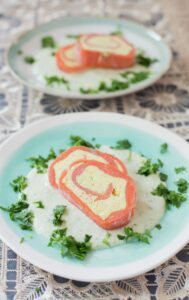 Smoked salmon roulade with cream cheese and avocado cream