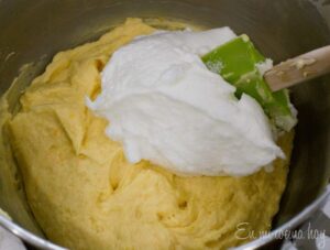 Adding the white eggs beaten to the dough