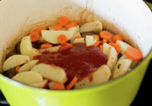 Tomato sauce added to potatoes and carrots