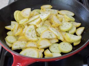 Slices of zucchini on a skillet.