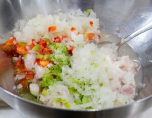 mixing fish and onion and seasonings