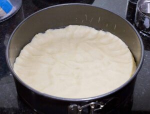 Dough at the bottom of the spring mold.