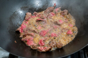 Browning beef in wok