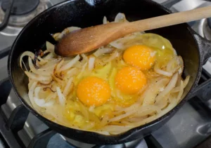 Eggs with onion in a cast iron.