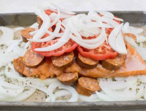 Raw salmon with longaniza, tomato and onion on top