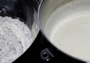 Two bowls: Batter for the cake and flour with poppy seeds.