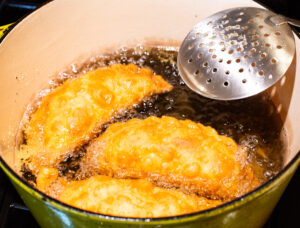 Frying empanadas.